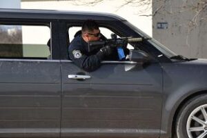 17th Security Forces Squadron Police Officer, John Hernandez, practices approaching the scene of an active shooter during the tactical driving course at the shoot house on Goodfellow Air Force Base, Texas, Feb. 27, 2019. Individuals practiced engaging targets while operating a vehicle and navigating through multiple advanced driving courses. (U.S. Air Force photo by Senior Airman Seraiah Hines/Released)